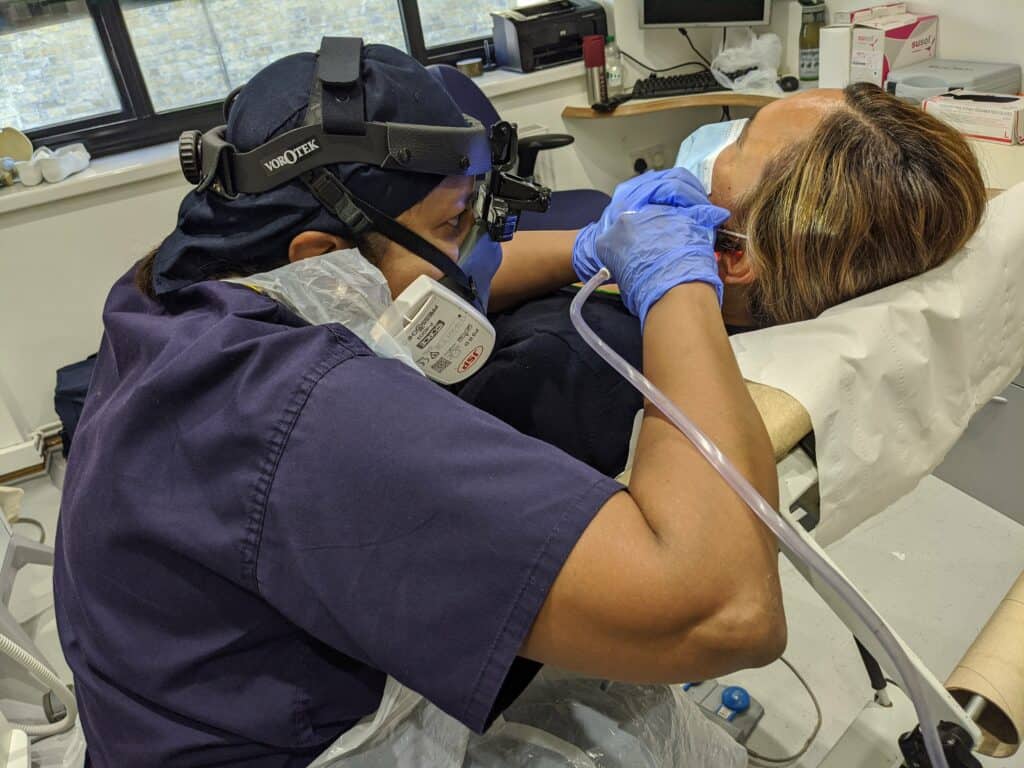 geeta patel performing ear wax removal procedure ppe